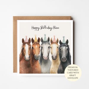 May include: A square greeting card featuring a watercolour illustration of five horses wearing colourful party hats. The text Happy Birthday Alice is printed in black script above the horses. The card is paired with a brown kraft envelope.