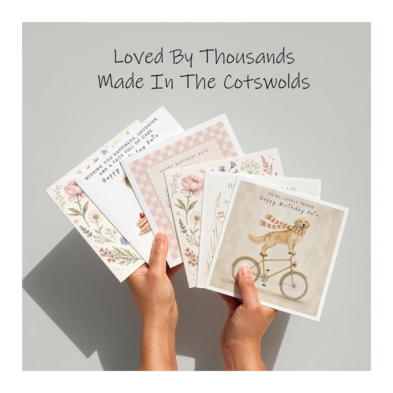 A pair of hands holding a collection of birthday cards, each featuring a different design and message.