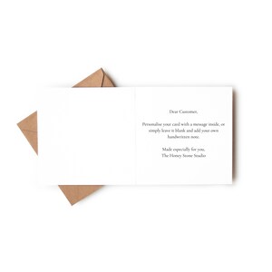 a blank card with a message written on it, placed on top of a brown envelope.