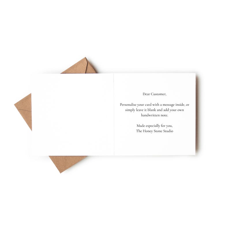 a blank card with a message written on it, placed on top of a brown envelope.