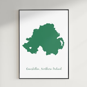May include: A green outline of Northern Ireland with a white heart marking the location of Enniskillen. The text "Enniskillen, Northern Ireland" is printed below the map.