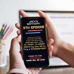 May include: A smartphone displaying a Star Wars themed birthday invitation for Jack's 5th birthday party. The invitation features a dark blue background with yellow text and red and blue lightsabers. The text reads "Jack's Birthday 5th Episode" and includes details about the party, including the date, time, location, and RSVP information. The invitation also includes the text "Come to the Dark Side There will be cake."