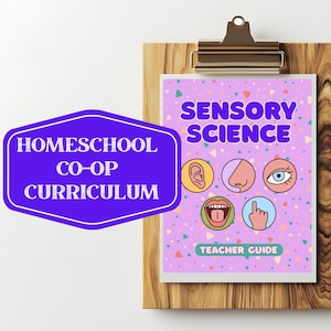 May include: A wooden clipboard holds a purple and white "Sensory Science" teacher guide. The guide features illustrations of the five senses. A purple sign with white text reads "Homeschool Co-Op Curriculum".