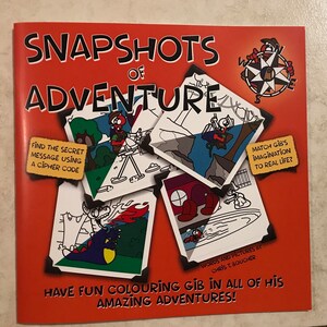 May include: A red book titled "Snapshots of Adventure" featuring a compass illustration. The book contains black and white illustrations of a character named Gib on various adventures. The text "Find the secret message using a cipher code" and "Match Gib's imagination to real life?" are included. The book is for colouring and features the text "Have fun colouring Gib in all of his amazing adventures!"