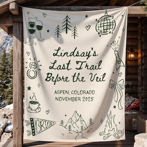 May include: A cream-colored banner with dark green illustrations and text. The banner reads "Lindsay's Last Trail Before the Veil" with additional text indicating the location and date. The design includes images of champagne glasses, a disco ball, and a ring.