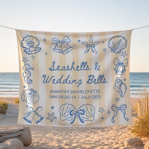 May include: A rectangular fabric banner with vertical beige and white stripes featuring blue line art illustrations of seashells, starfish, seahorses, and wedding bells. The text reads Seashells & Wedding Bells, AMANDA'S BACHELORETTE, SAN DIEGO, CA / JULY 2026.