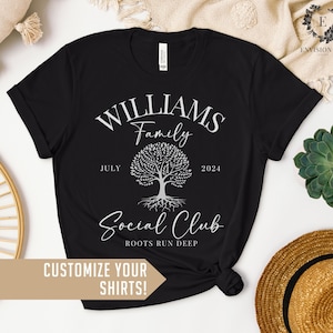 May include: Black t-shirt with a white graphic of a tree with roots and the text "WILLIAMS Family" above the tree and "Social Club" below the tree. The text "JULY" and "2024" are on either side of the tree. The text "ROOTS RUN DEEP" is below the words "Social Club".