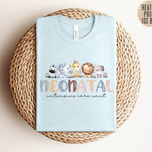 May include: Light blue t-shirt with a graphic of a line of cute animals and the text "NEONATAL intensive care unit".