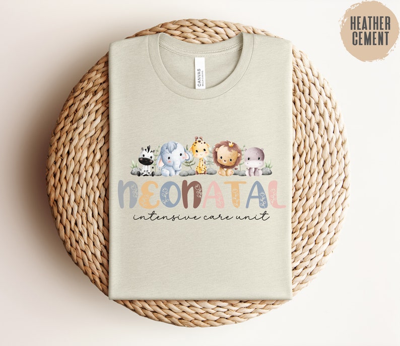 May include: A light beige t-shirt with a graphic of a line of cartoon animals and the text "NEONATAL intensive care unit".