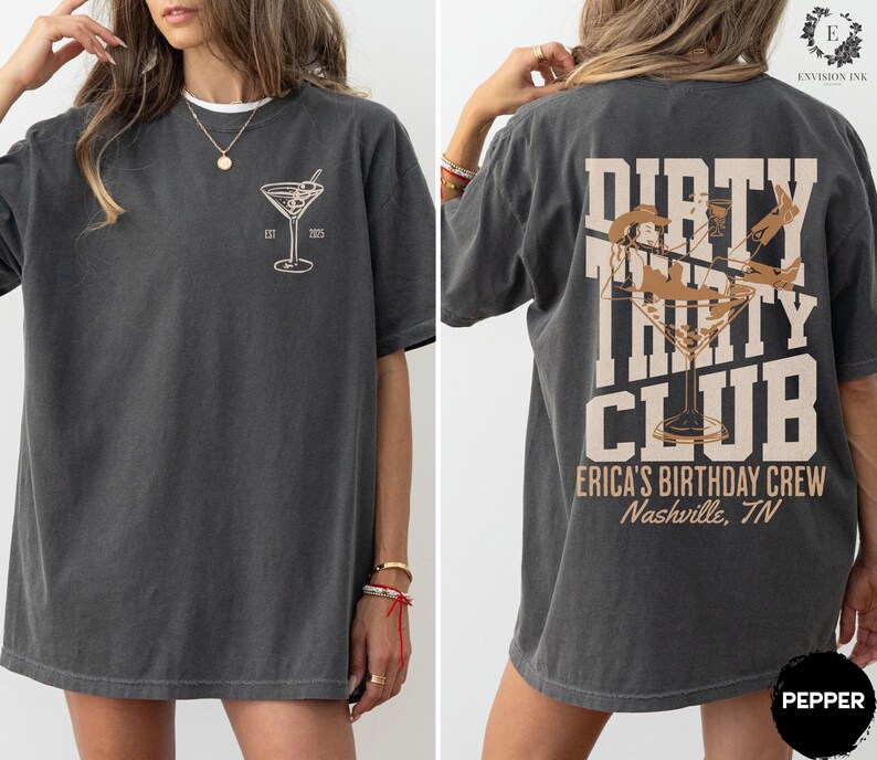 May include: A dark gray t-shirt with a martini glass graphic on the front and the text "Dirty Thirty Club" with a martini glass graphic on the back. The text on the back also includes "Erica's Birthday Crew" and "Nashville, TN".