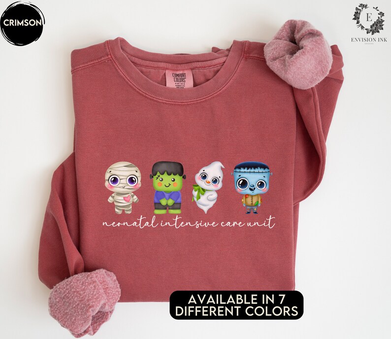May include: A maroon sweatshirt featuring a graphic of four cartoon monsters and the text "neonatal intensive care unit". The sweatshirt is available in seven different colours.