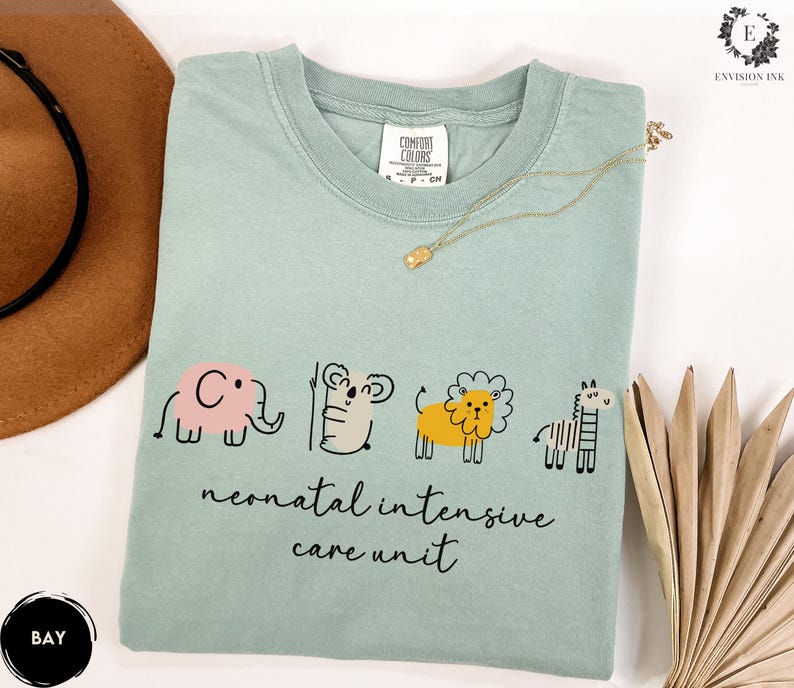 May include: A light blue t-shirt with a graphic of an elephant, koala, lion, and zebra. The text "neonatal intensive care unit" is printed below the animals.