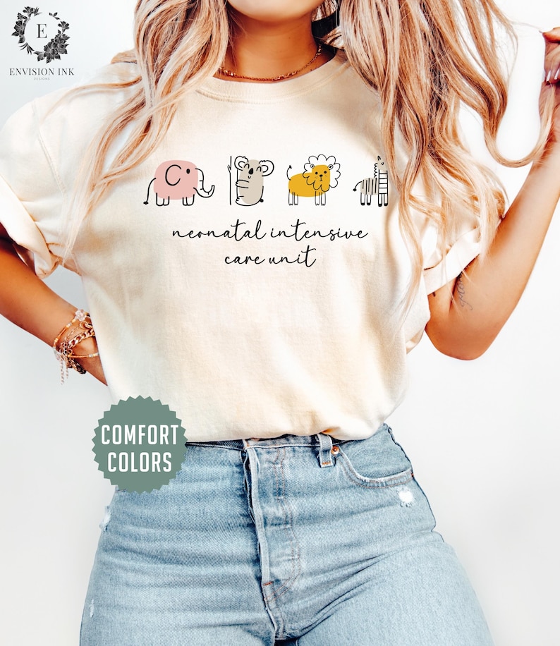 May include: A white t-shirt with a graphic of a pink elephant, a brown koala, a yellow lion, and a black and white zebra. The text "neonatal intensive care unit" is printed below the graphic.