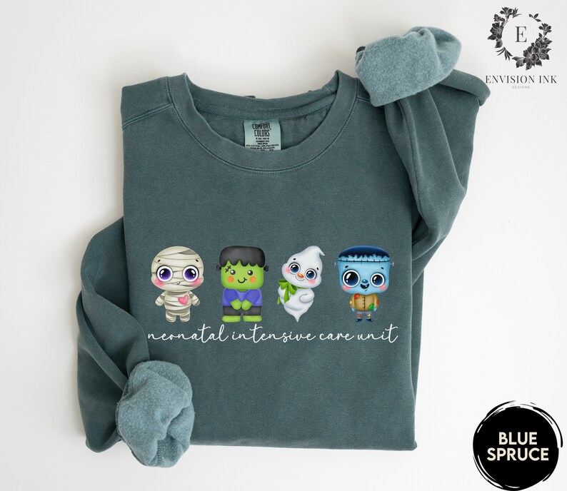 May include: A teal blue sweatshirt with a graphic of four Halloween-themed characters and the text "neonatal intensive care unit".