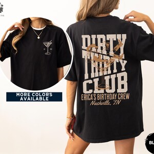 May include: Black t-shirt with a brown graphic of a martini glass and the text "Dirty Thirty Club" with the words "Erica's Birthday Crew Nashville, TN" below.