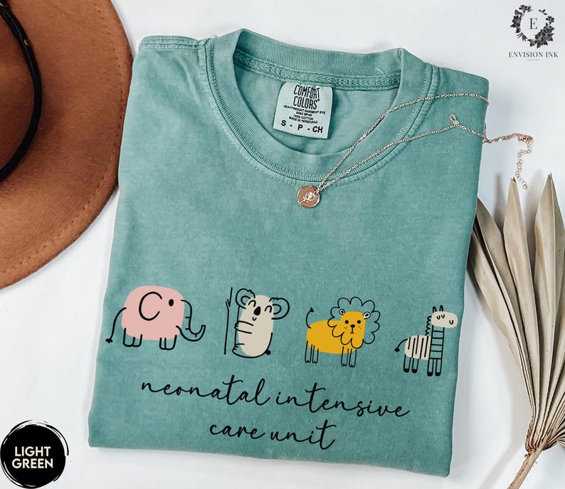 May include: Light green t-shirt with a graphic of an elephant, koala, lion, and zebra. The text "neonatal intensive care unit" is printed below the graphic.