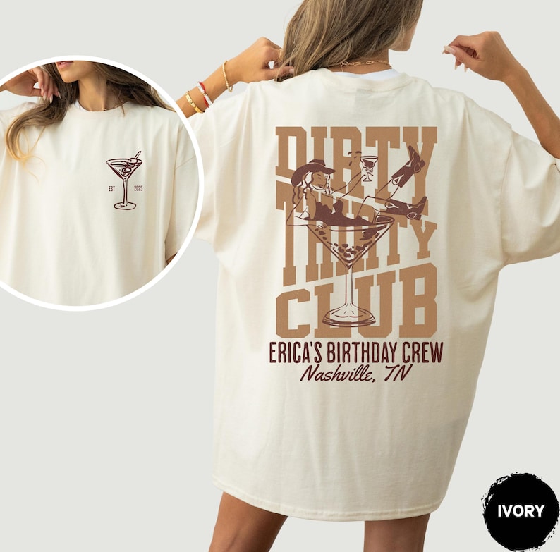 May include: Ivory t-shirt with a brown graphic of a woman in a cowboy hat sitting in a martini glass. The text "Dirty Thirty Club" is printed above the graphic. The text "Erica's Birthday Crew Nashville, TN" is printed below the graphic.