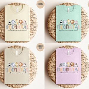 May include: Four t-shirts in different colors with a design of a group of cartoon animals and the text "NEONATAL intensive care unit". The colors are natural, heather dust, heather prism mint, and heather prism lilac.