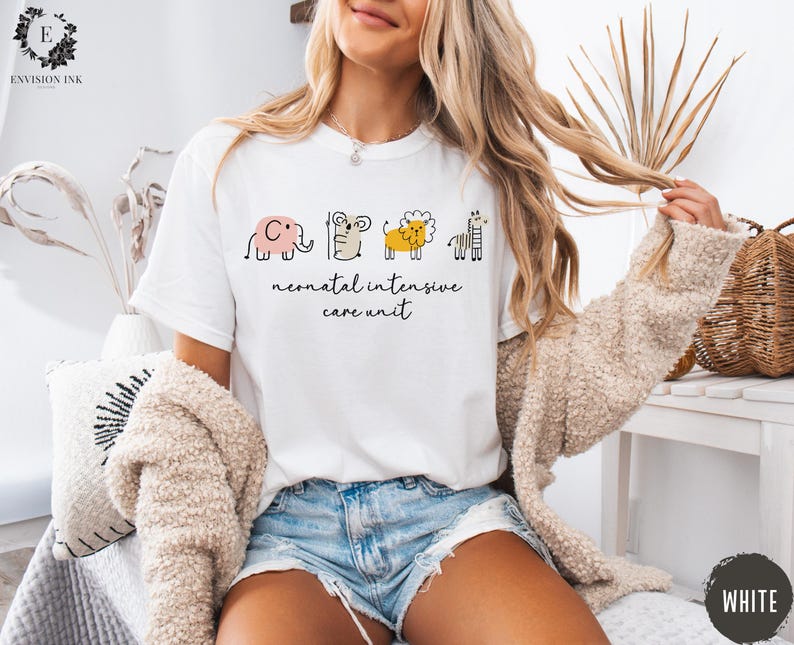 May include: White t-shirt with a graphic of a line of animals, including an elephant, a mouse, a lion, and a giraffe. The text "neonatal intensive care unit" is printed below the animals.