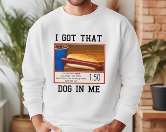 May include: White sweatshirt with a graphic of a hot dog and a soda with the text "I got that dog in me" and "1/4 pound plus all beef hot dog and 20 oz. soda (with refill) 580-850 cal. 1.50"