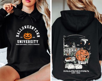 May include: Black hooded sweatshirt with "Halloweentown University" graphic. The front features a jack-o'-lantern and text. The back displays a Halloween scene with a pumpkin, buildings, and the text "Halloweentown Est. 1998".