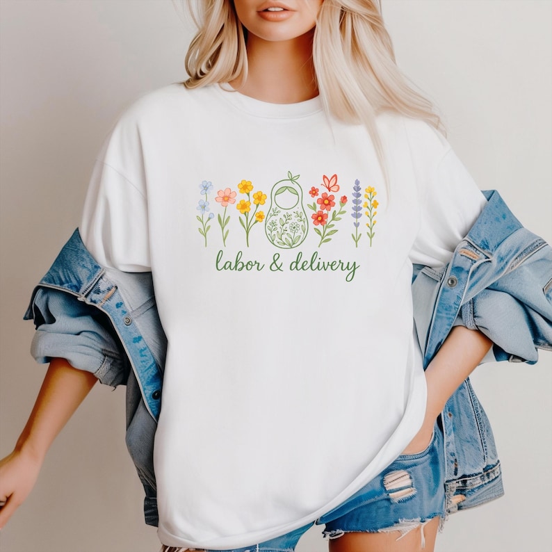 May include: White t-shirt with a green floral design and the text "labor & delivery".