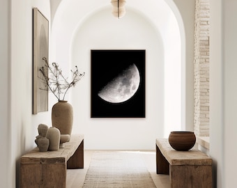 May include: A hallway with white walls and arched doorways. A wooden bench with a bowl on it is on the right side of the image. A wooden bench with a vase and other decorative items is on the left side of the image. A black and white photograph of a crescent moon hangs on the wall.