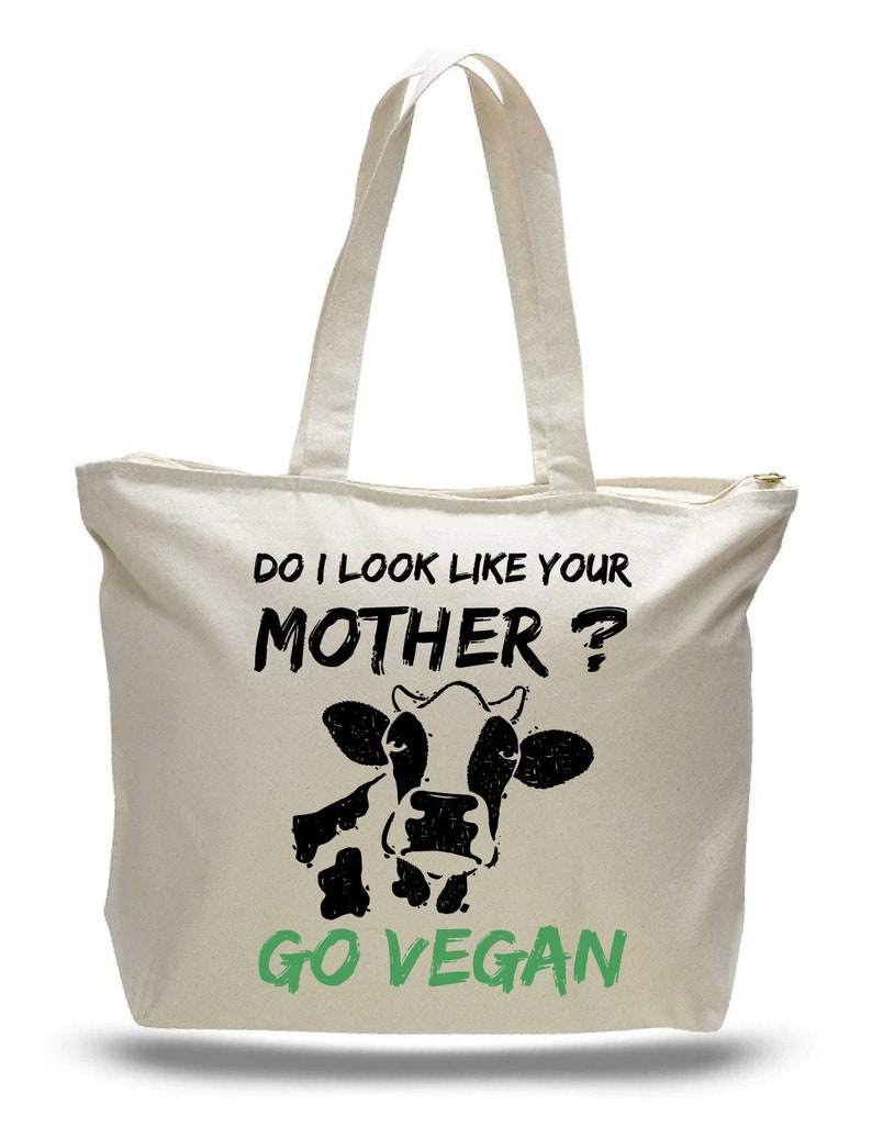 Zippered tote bag with printed message that says "Do I look like your Mohter?Go vegan"with the image of a cow