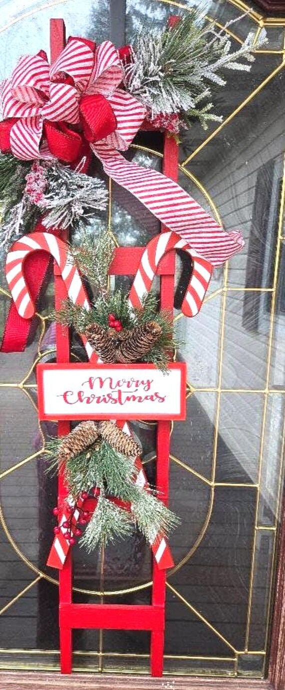 Candy Cane Christmas Ladder is an adorable bright red wood ladder with holiday florals and holiday candy cane sign