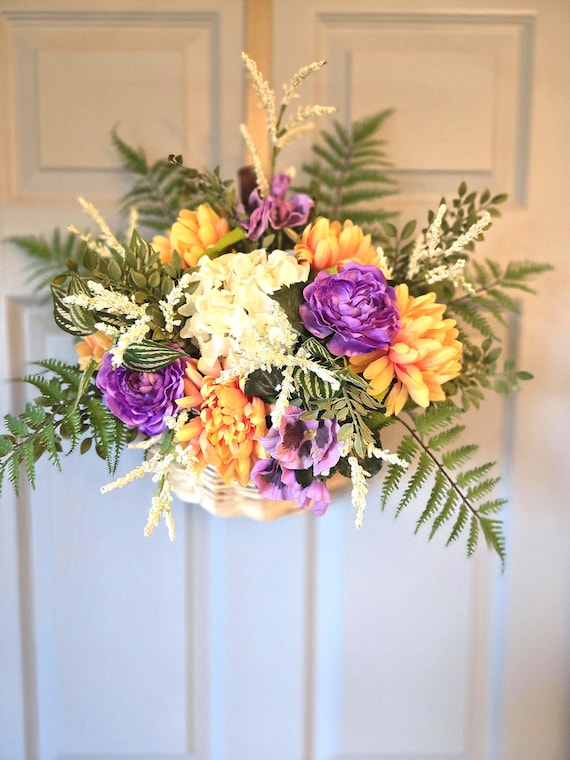 Easter or Spring Door Basket done in a natural wicker with faux florals in peach, lavender and white will add a touch of Spring to your home