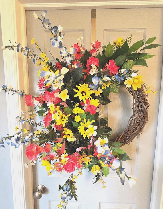 Spring Wild Flower Grapevine Wreath with faux wild flowers in yellows, blues and reds.