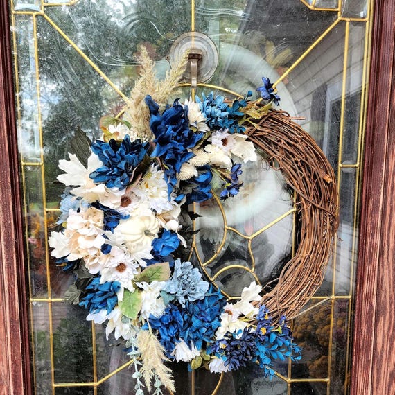 Fall Grapevine Wreath with deep blue and cream florals with matching cream pumpkins. Give your door a unique look for fall.