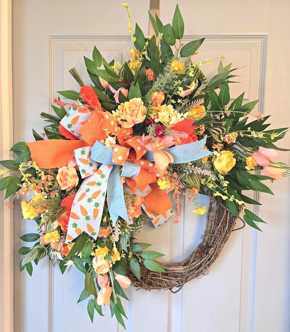 Charming Easter Wreath done in vibrant shades of orange and yellow with bright orange velore carrot attachments.