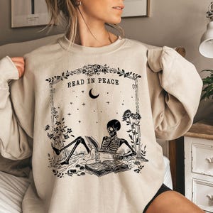 Read in Peace Sweatshirt, Skeleton Halloween Sweatshirt, Book Lover Skeleton Sweatshirt, Spooky Halloween Gift, Skeleton Reading Sweatshirt