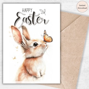 Peut inclure: Une carte blanche avec le texte "Happy Easter" en écriture cursive noire. Une illustration aquarelle d'un lapin brun avec un papillon sur le nez. Le lapin regarde le papillon.