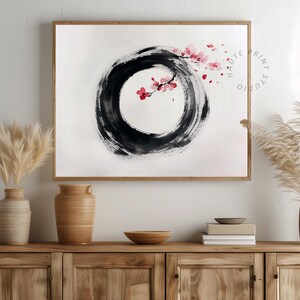 May include: A framed art print featuring a black ink circle with a cherry blossom branch. The artwork has a minimalist style with a white background and a wooden frame. The text "HAUTE PRINT STUDIO" is visible on the right side of the print.