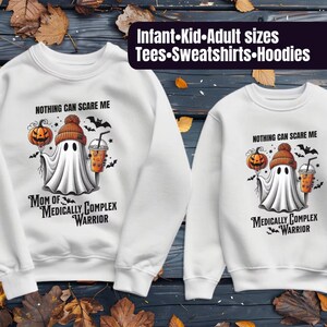 May include: White crewneck sweatshirt with a ghost holding a pumpkin and a cup of coffee. The text on the sweatshirt reads "Nothing can scare me. Mom of Medically Complex Warrior."