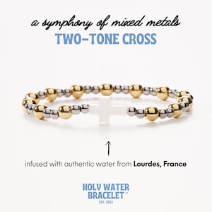 May include: A gold and silver beaded bracelet with a white cross charm. The bracelet is infused with authentic water from Lourdes, France. "Holy Water Bracelet" is printed on the tag.