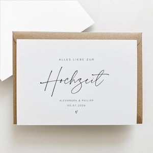 Puede incluir: Una tarjeta blanca con las palabras "ALLES LIEBE ZUR Hochzeit" en escritura negra, con los nombres "ALEXANDRA & PHILIPP" y la fecha "05.07.2026" debajo. La tarjeta est&aacute; dentro de un sobre marr&oacute;n.