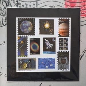May include: A collection of space-themed postage stamps, including images of planets, nebulae, and a space shuttle, mounted on a black mat. Stamps feature text such as "Mercury", "Jupiter", "Ring Nebula", and "First Moon Landing".