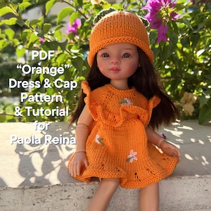 Puede incluir: Patrón y tutorial PDF para un vestido y una gorra de punto naranja para una muñeca Paola Reina. La muñeca lleva el vestido y la gorra, que presentan un diseño floral.