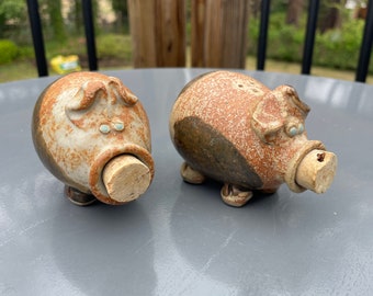 Pair of stoneware art pottery pig salt and pepper shakers with cork nose