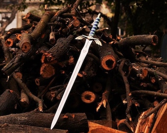 May include: A silver sword with a blue and white handle, lying on a pile of brown branches.