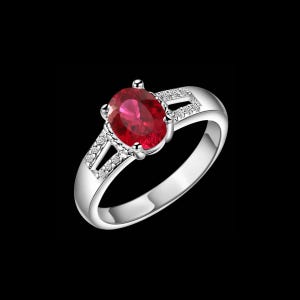 May include: A silver-toned ring featuring a large, oval-cut, deep red gemstone held by four prongs. The band is split at the shoulders, with each side accented by a row of small, clear, round-cut stones set into the polished metal surface.