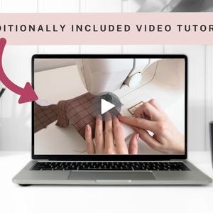 May include: A laptop displays a video tutorial on sewing. The screen shows hands working with fabric near a sewing machine. The text "ADDITIONALLY INCLUDED VIDEO TUTORIAL" is above the laptop. A wooden pencil holder and a black mug are on the table.