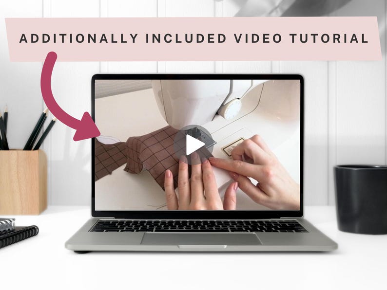 May include: A laptop displays a video tutorial on sewing. The screen shows hands working with fabric near a sewing machine. The text "ADDITIONALLY INCLUDED VIDEO TUTORIAL" is above the laptop. A wooden pencil holder and a black mug are on the table.