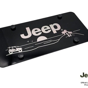 May include: Black Jeep license plate with a white Jeep logo, a white Jeep silhouette driving on a beach with palm trees and a sunset. The text "Jeep" is in the upper center of the plate.