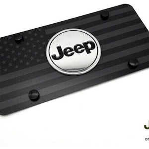 May include: Black and silver Jeep license plate frame with a black and white American flag design and the word "Jeep" in a silver circle.