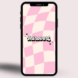 May include: A smartphone showing a pink and cream chequered pattern wallpaper with the word "Introvert" in a retro font. The phone has a black border and a sleek design.