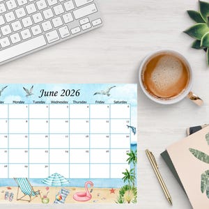 May include: A June 2026 calendar with a beach theme. The calendar features illustrations of seagulls, dolphins, palm trees, a beach chair, and a pink flamingo. A cup of coffee, a pen, and a keyboard are also visible.